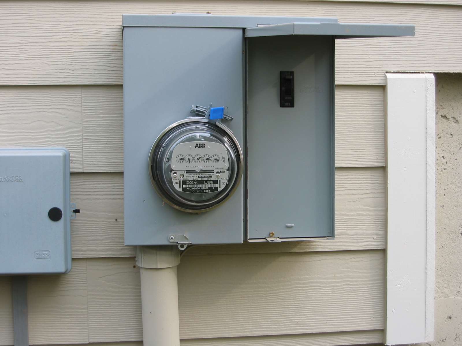Picture of a electric service meter mounted on the side of a house